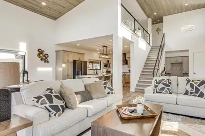 a living room with a couch and a table at 1 Mi to Granby Ranch Luxe Home with Mtn Views! in Granby
