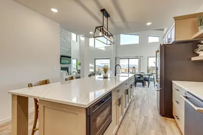 a large kitchen with a large white counter top at 1 Mi to Granby Ranch Luxe Home with Mtn Views! in Granby