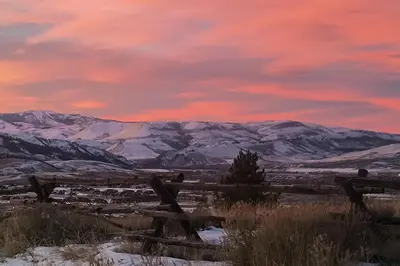a sunset over a mountain range with snow covered mountains at 1 Mi to Granby Ranch Luxe Home with Mtn Views! in Granby