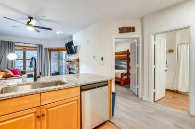 a kitchen with a sink and a living room at Walk to Ski Lift and Hot Tubs! Mtn-View Keystone Gem in Keystone