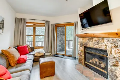 a living room with a fireplace and a tv at Walk to Ski Lift and Hot Tubs! Mtn-View Keystone Gem in Keystone