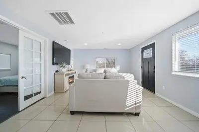 a living room with a white couch and a television at Near Downtow 3Bed 2 Bath in Denver Explore Colorado in Denver