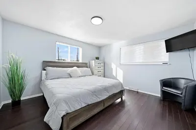 a bedroom with a bed and a chair in it at Near Downtow 3Bed 2 Bath in Denver Explore Colorado in Denver