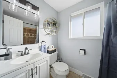 a bathroom with a sink and a toilet and a mirror at Near Downtow 3Bed 2 Bath in Denver Explore Colorado in Denver