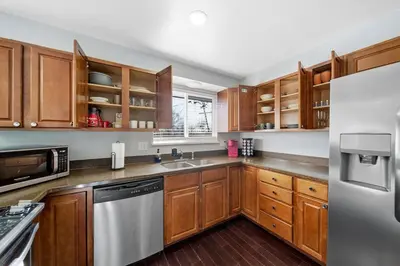 a kitchen with wooden cabinets and stainless steel appliances at Near Downtow 3Bed 2 Bath in Denver Explore Colorado in Denver
