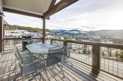 a balcony with a table and chairs on a deck at Hot Tub and Amazing Views Luxury Winter Park Haven! in Winter Park