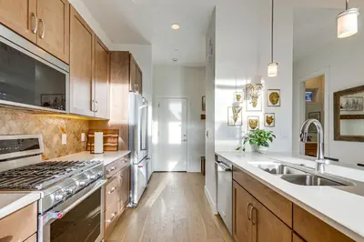 a kitchen with a sink and a stove top oven at Hot Tub and Amazing Views Luxury Winter Park Haven! in Winter Park
