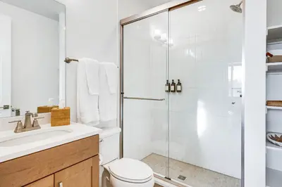 a bathroom with a shower and a toilet and a sink at Hot Tub and Amazing Views Luxury Winter Park Haven! in Winter Park