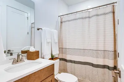 a bathroom with a sink and a shower curtain at Hot Tub and Amazing Views Luxury Winter Park Haven! in Winter Park