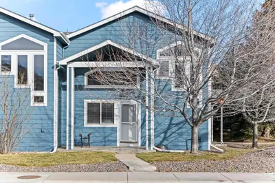 a blue house with a tree in front of it at Golden View Townhouse - Walk to Downtown! in Golden