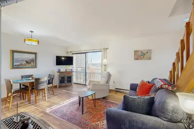 a living room with a couch and a table at Next To Nature in Grand Lake