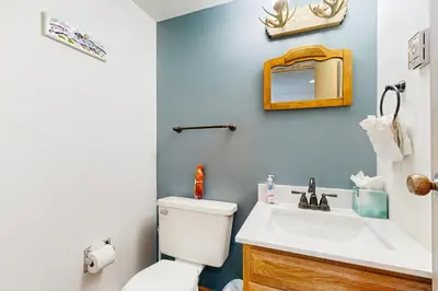 a bathroom with a white toilet and a sink at Next To Nature in Grand Lake