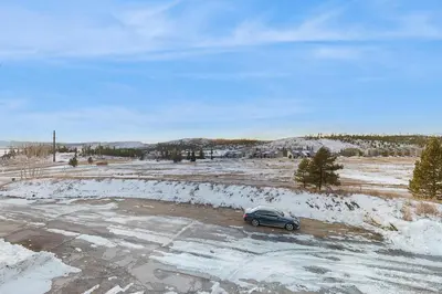 a car parked in a parking lot with snow at Next To Nature in Grand Lake