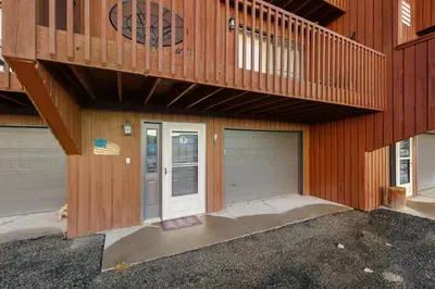 a house with two garage doors and a balcony at Next To Nature in Grand Lake