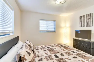 a bedroom with a bed and a flat screen tv at Ski, Hike and Snowmobile Mtn-View Grand Lake Gem! in Grand Lake