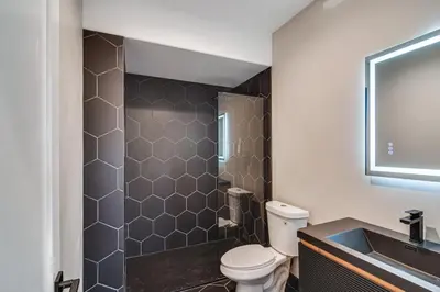 a bathroom with a toilet and a sink at Great for Gatherings! Evergreen Getaway with Hot Tub in Evergreen