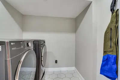 a laundry room with a washer and dryer at Great for Gatherings! Evergreen Getaway with Hot Tub in Evergreen