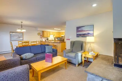 a living room with a couch and chairs and a fireplace at Steps to Free Ski Shuttle! Dtwn Winter Park Condo in Winter Park