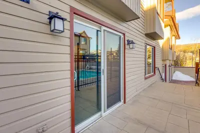 a sliding glass door on a house with a patio at Steps to Free Ski Shuttle! Dtwn Winter Park Condo in Winter Park