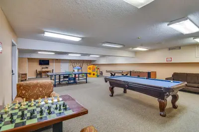 a living room with a pool table and ping pong tables at Steps to Free Ski Shuttle! Dtwn Winter Park Condo in Winter Park