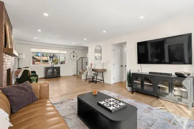 a living room with a couch and a tv at Haus Vango in Arvada