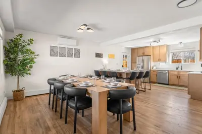 a kitchen and dining room with a table and chairs at Haus Vango in Arvada