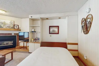 a living room with a bed and a tv at Iron Horse Resort #C1083 in Winter Park