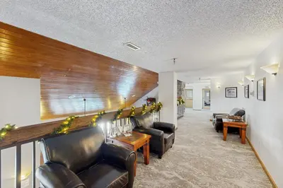 a living room with leather furniture and a wall at Iron Horse Resort #C1083 in Winter Park