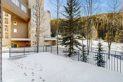 a balcony of a building with footprints in the snow at Iron Horse Resort #C1083 in Winter Park