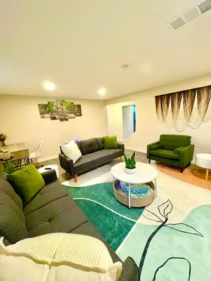 a living room with a couch and a table at Private Residence Below Basement in Thornton