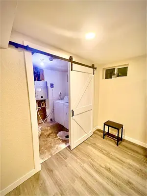 an empty room with a door open to a kitchen at Private Residence Below Basement in Thornton