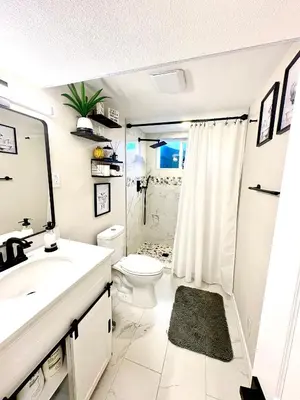 a white bathroom with a sink and a toilet at Private Residence Below Basement in Thornton
