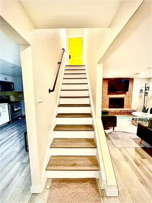 a staircase with a yellow door and a yellow door at Private Residence Below Basement in Thornton