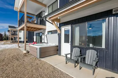 a balcony with two chairs and a desk on a house at The Fox Den: Cozy & Fun with Amazing Views in Fraser