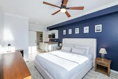 a blue bedroom with a bed and a ceiling fan at The Fox Den: Cozy & Fun with Amazing Views in Fraser