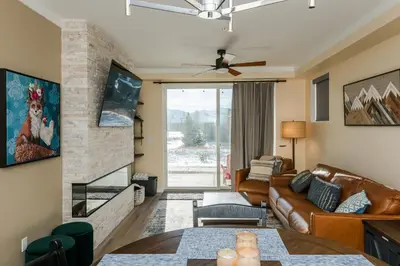 a living room with a couch and a fireplace at The Fox Den: Cozy & Fun with Amazing Views in Fraser
