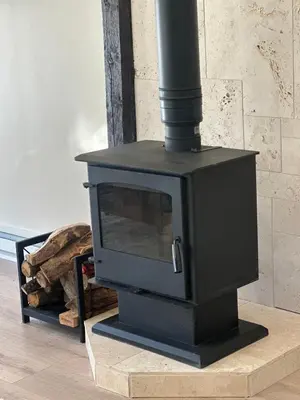 a black stove sitting on a table in a room at Modern barn by the creek in Evergreen