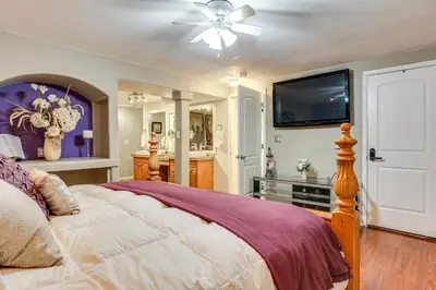 a bedroom with a bed and a flat screen tv at Group Getaway 3 Mi to Cherry Creek State Park! in Aurora