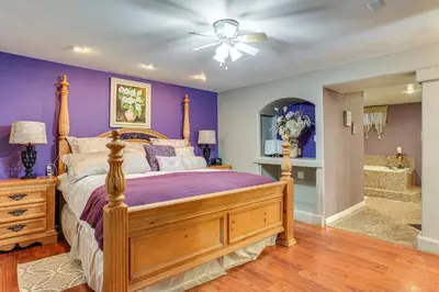 a bedroom with a bed with purple walls and a ceiling at Group Getaway 3 Mi to Cherry Creek State Park! in Aurora