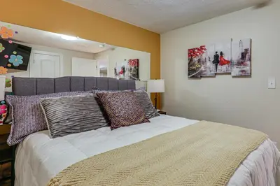 a bedroom with a large bed with pillows on it at Group Getaway 3 Mi to Cherry Creek State Park! in Aurora