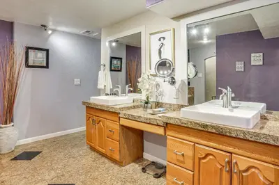 a bathroom with two sinks and a large mirror at Group Getaway 3 Mi to Cherry Creek State Park! in Aurora