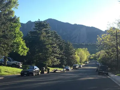 a road with cars parked on the side of a mountain at Spa Getaway with Open Space Access Sauna & Hot Tub & Cold Plunge in Boulder