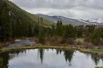 a river with trees and mountains in the background at Keystone Charm- Wild Irishman 3BR Mountain Escape condo in Keystone