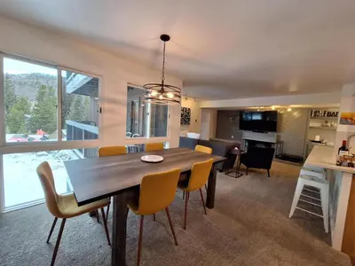 a dining room and living room with a table and chairs at Keystone Charm- Wild Irishman 3BR Mountain Escape condo in Keystone