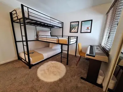 a bedroom with two bunk beds and a desk at Keystone Charm- Wild Irishman 3BR Mountain Escape condo in Keystone
