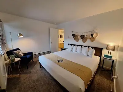 a hotel room with a large bed and a chair at Keystone Charm- Wild Irishman 3BR Mountain Escape condo in Keystone