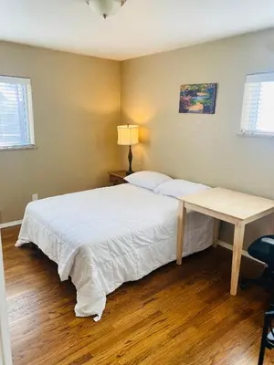 a bedroom with a bed and a desk in it at Master Bedroom and Bath in Arvada