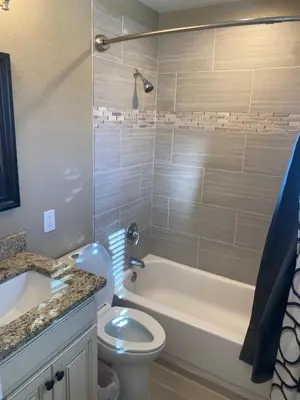 a bathroom with a tub and a toilet and a sink at Master Bedroom and Bath in Arvada