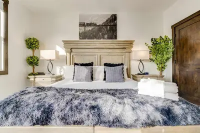 a bedroom with a large bed with a blue blanket at Keystone 5BD 5 5BT Luxury Remodel 2025 & Pets in Keystone