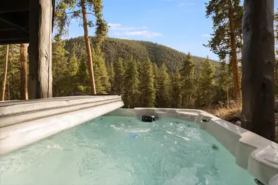 a hot tub in the middle of a forest at Keystone 5BD 5 5BT Luxury Remodel 2025 & Pets in Keystone
